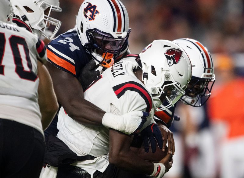 Auburn Tigers buck Keyron Crawford (24) sacks Ball State Cardinals quarterback Kiael Kelly (1) as Auburn Tigers take on Ball State Cardinals at Jordan-Hare Stadium in Auburn, Ala. on Saturday, Sept. 6, 2025. Auburn Tigers lead Ball State Cardinals 21-0 at halftime.