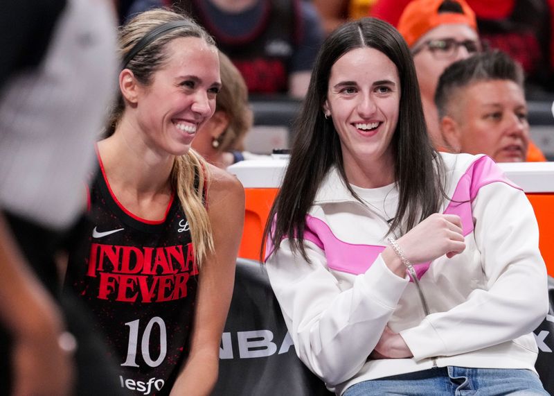 Indiana Fever guard Lexie Hull (10) and Indiana Fever guard Caitlin Clark (22) laugh from the bench Tuesday, Sept. 9, 2025, during a game between the Indiana Fever and the Minnesota Lynx at Gainbridge Fieldhouse in Indianapolis. The Indiana Fever defeated the Minnesota Lynx, 83-72.