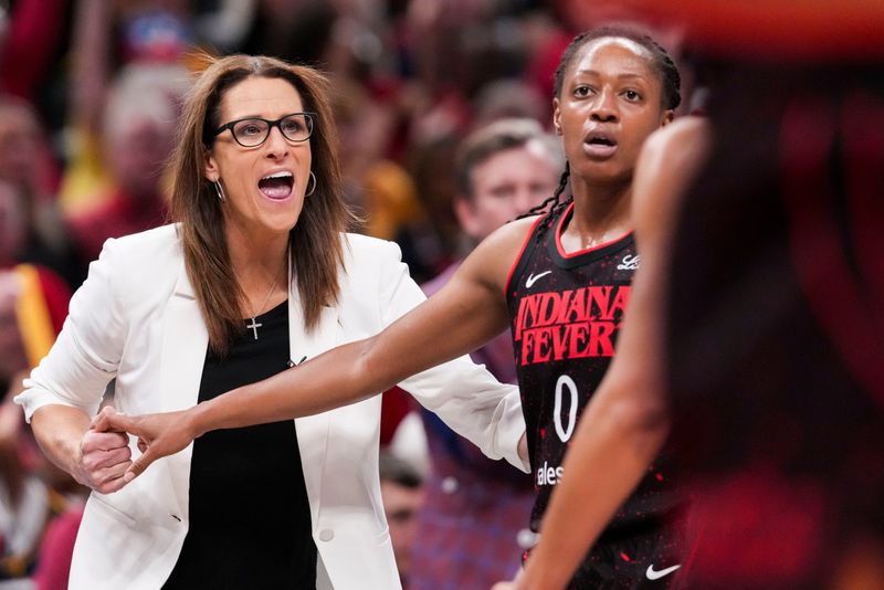 Indiana Fever head coach Stephanie White celebrates with Indiana Fever guard Kelsey Mitchell (0) on Tuesday, Sept. 9, 2025, during a game between the Indiana Fever and the Minnesota Lynx at Gainbridge Fieldhouse in Indianapolis. The Indiana Fever defeated the Minnesota Lynx, 83-72.