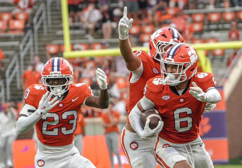 Clemson CB Ricardo Jones (6) returns an interception for a touchdown after CB Ashton Hampton (23) broke up a pass for Troy Trojans WR Roman Mothershed (0) during the third quarter at Memorial Stadium in Clemson, S.C. Saturday, September 6, 2025.