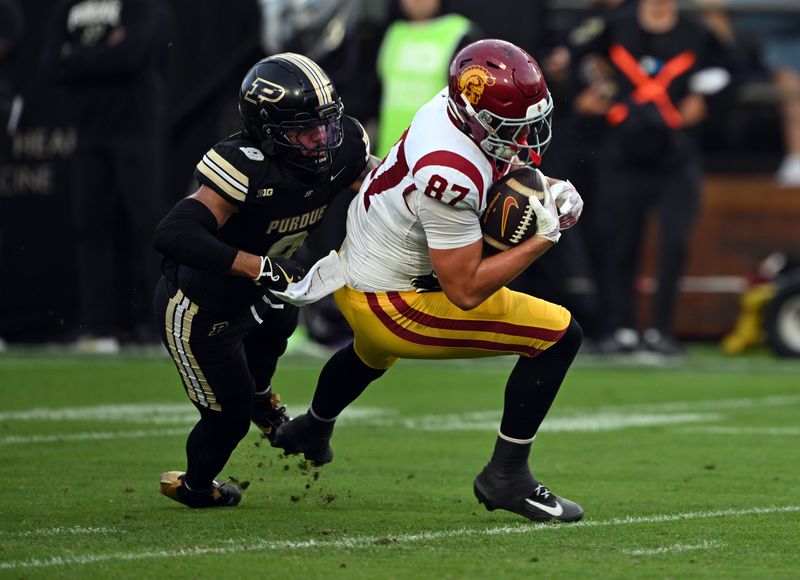 USC tight end Lake McRee is tackled by Purdue defensive back Myles Slusher during the first quarter Saturday, Sept. 13, 2025, at Ross-Ade Stadium.