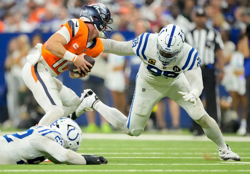 Indianapolis Colts defensive tackle DeForest Buckner (99) brings down Denver Broncos quarterback Bo Nix (10) on Sunday, Sept. 14, 2025, during a game at Lucas Oil Stadium in Indianapolis.