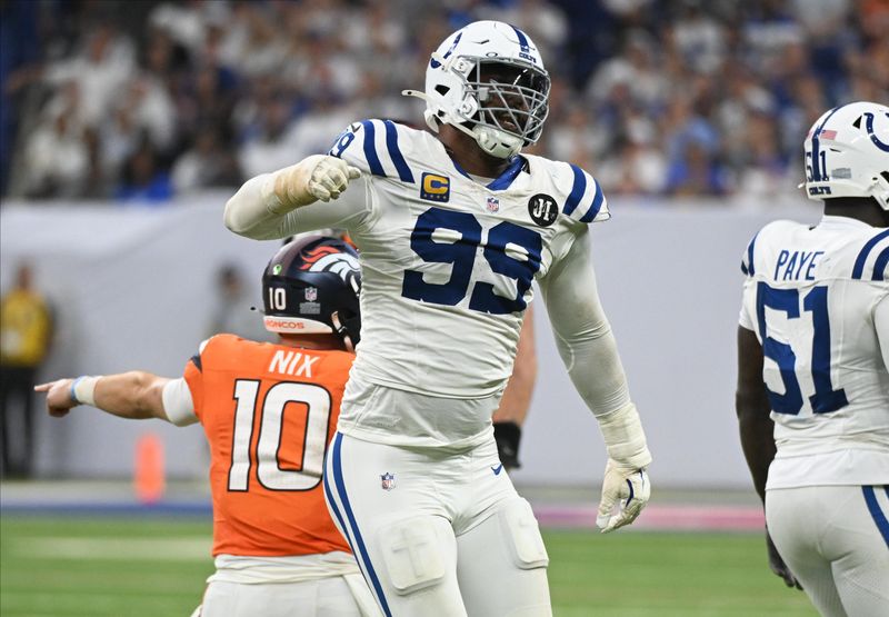 Sep 14, 2025; Indianapolis, Indiana, USA; Indianapolis Colts defensive tackle DeForest Buckner (99) celebrates a tackle against Denver Broncos quarterback Bo Nix (10) during the fourth quarter at Lucas Oil Stadium. Mandatory Credit: Robert Goddin-Imagn Images