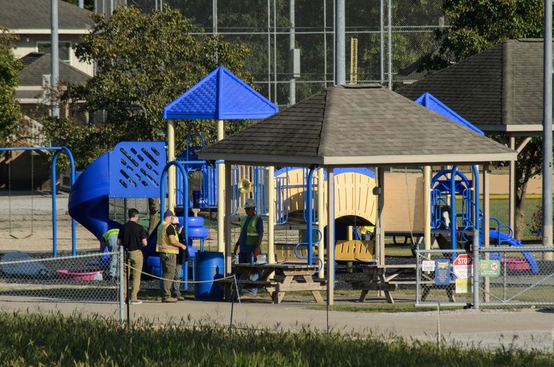 U.S. Environmental Protection Agency officials and contractors are seen cleaning ash from a playground at Vann Park on Sept. 9, 2025, after the PBTT Corp. fire in Newburgh, Indiana.