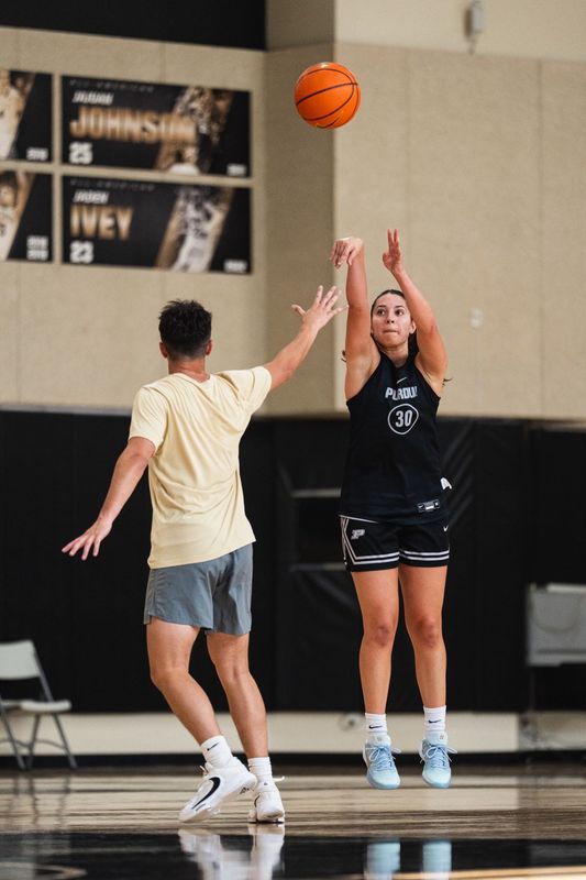 Purdue freshman guard Hila Karsh (right) fires a 3-pointer (right) over a practice player at Cardinal Court in West Lafayette, Indiana.