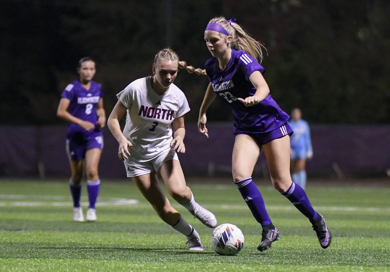 Bloomington South’s Maddie Norman (23) dribbles the ball past Bloomington North’s Caroline Farmer (3) during the Bloomington South-Bloomington North girls’ soccer match at South on Wednesday, Sept. 17, 2025.
