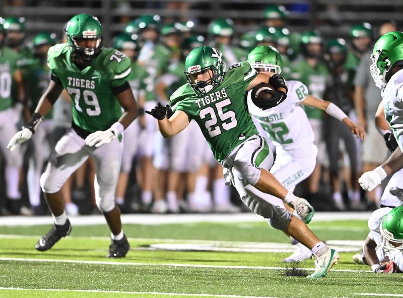 Yorktown senior Nate Luzadder breaks away into open field during a football game against New Castle Friday, Sept. 19, 2025, at Yorktown High School.