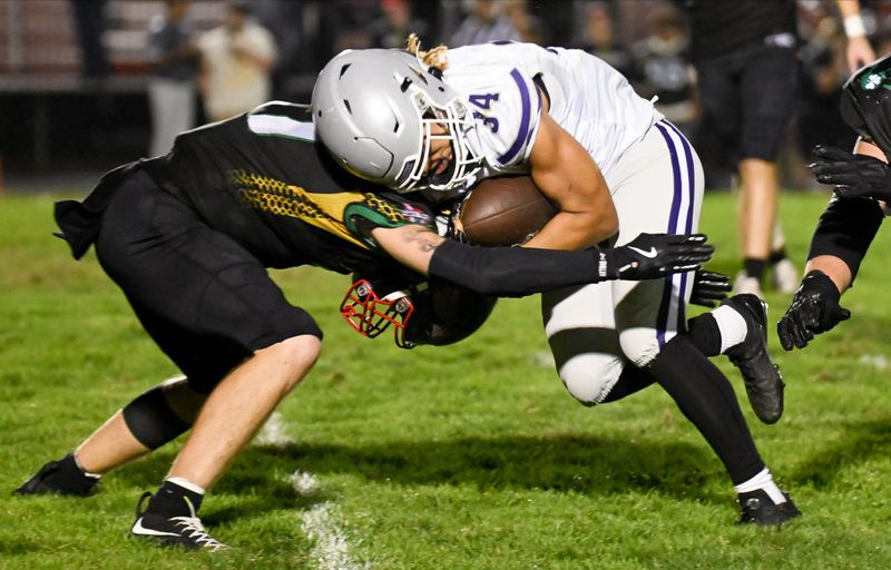 Bloomington South’s Shaun Cooper (34) runs the ball during the football game at Terre Haute South on Friday, Sept. 19, 2025.
