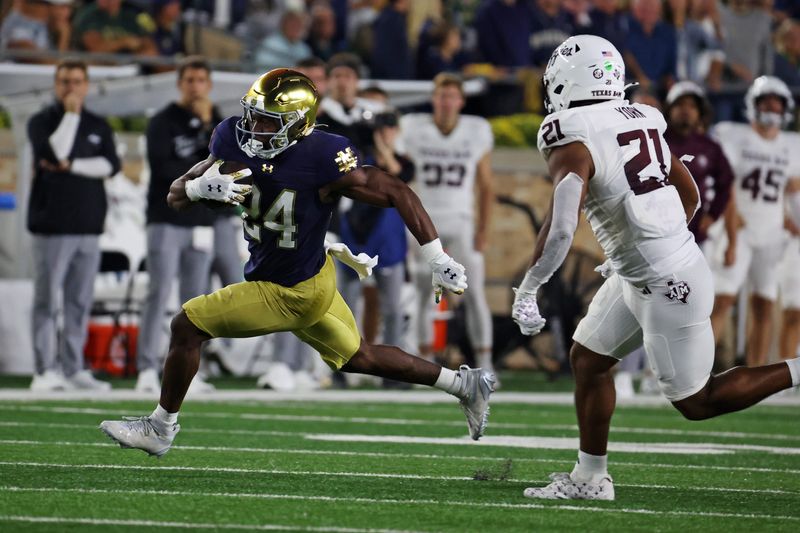Sep 13, 2025; South Bend, Indiana, USA; Notre Dame Fighting Irish running back Jadarian Price (24) runs the ball against Texas A&M Aggies during the first half at Notre Dame Stadium. Mandatory Credit: Trevor Ruszkowski-Imagn Images