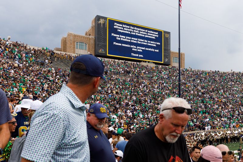Fans evacuate the stadium for a lightning delay during the first half of a NCAA football game between Notre Dame and Purdue at Notre Dame Stadium on Saturday, Sept. 20, 2025, in South Bend.