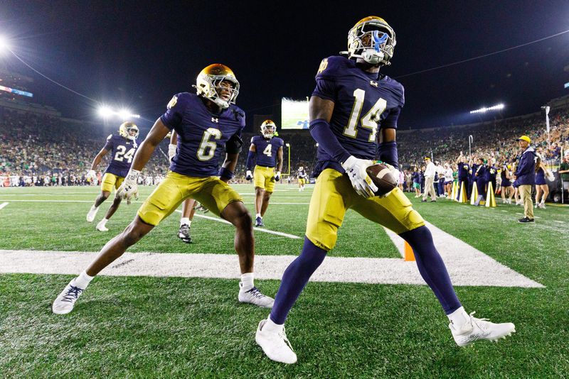Notre Dame cornerback Dallas Golden (14) and cornerback Christian Gray (6) celebrate a Golden interception during the second half of a NCAA football game against Purdue at Notre Dame Stadium on Saturday, Sept. 20, 2025, in South Bend.
