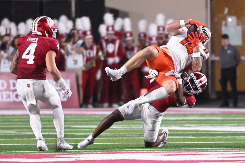 Sep 20, 2025; Bloomington, Indiana, USA; Indiana Hoosiers defensive back Louis Moore (7) tackles Illinois Fighting Illini tight end Cole Rusk (14) during the first half at Memorial Stadium. Mandatory Credit: Robert Goddin-Imagn Images