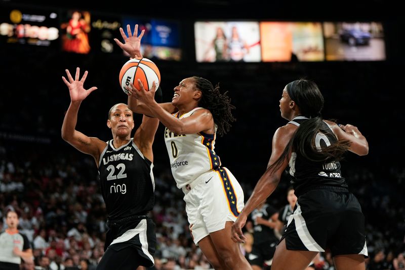 Indiana Fever guard Kelsey Mitchell attempts to score a layup against Las Vegas Aces center A'ja Wilson and guard Jackie Young during the second quarter in Game 1 of the second round for the 2025 WNBA Playoffs on Sunday, Sept. 21, 2025, at Michelob Ultra Arena. Mandatory Credit: Lucas Peltier-Imagn Images