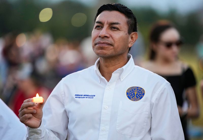 Secretary of State Diego Morales listens to speakers Sunday, Sept. 21, 2025, during a candlelight vigil for Charlie Kirk at Mulberry Fields in Zionsville.