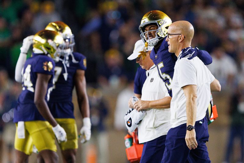 Notre Dame cornerback Leonard Moore is helped off the field in the first half of a NCAA football game against Texas A&M at Notre Dame Stadium on Saturday, Sept. 13, 2025, in South Bend.