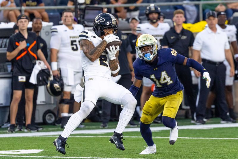 Sep 20, 2025; South Bend, Indiana, USA; Purdue Boilermakers wide receiver Michael Jackson III (2) makes a catch as Notre Dame Fighting Irish cornerback Dallas Golden (14) defends in the first half at Notre Dame Stadium. Mandatory Credit: Michael Caterina-Imagn Images