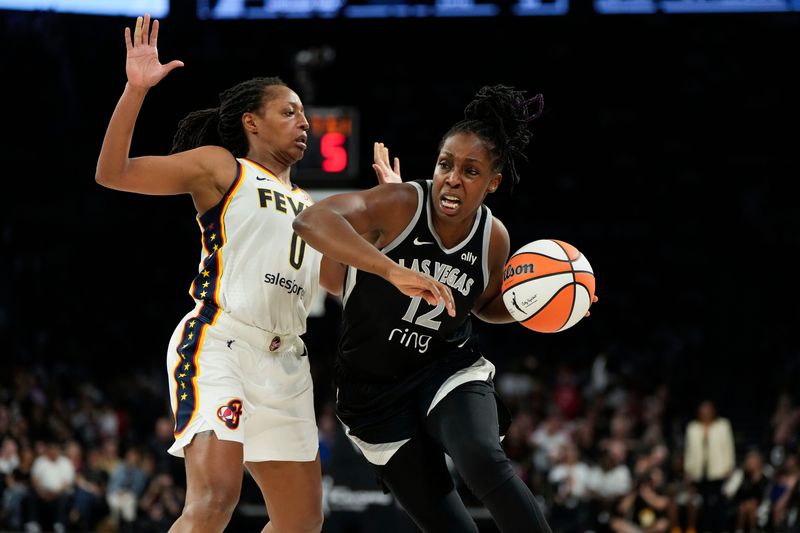 Sep 23, 2025; Las Vegas, Nevada, USA; Las Vegas Aces guard Chelsea Gray (12) drives against Indiana Fever guard Kelsey Mitchell (0) during the fourth quarter in game two of the second round for the 2025 WNBA Playoffs at Michelob Ultra Arena.
