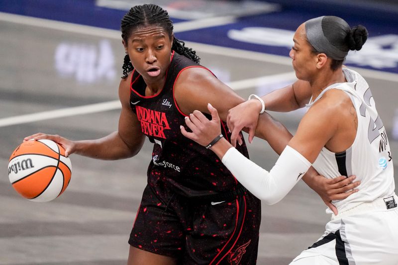 Indiana Fever forward Aliyah Boston (7) works to move past Las Vegas Aces center A'ja Wilson (22) on Friday, Sept. 26, 2025, during Game 3 of the WNBA semifinals against the Las Vegas Aces at Gainbridge Fieldhouse in Indianapolis.