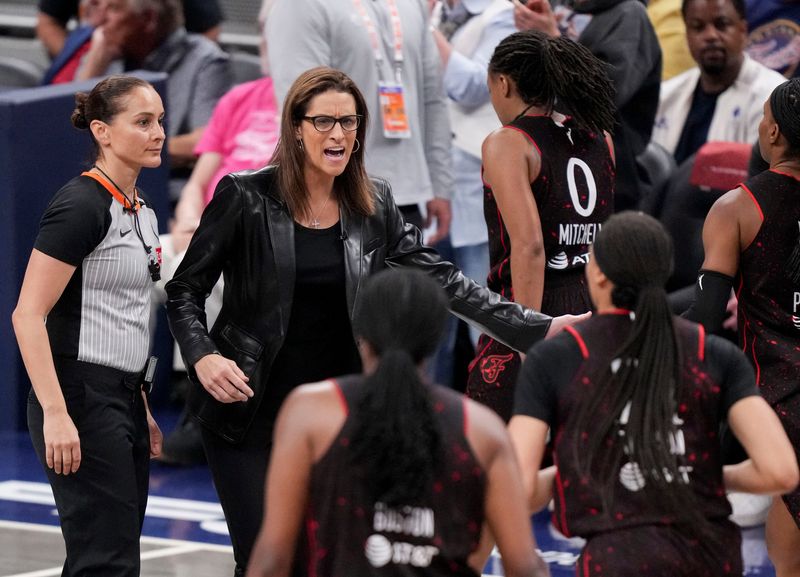 Indiana Fever head coach Stephanie White high fives players Friday, Sept. 26, 2025, during Game 3 of the WNBA semifinals against the Las Vegas Aces at Gainbridge Fieldhouse in Indianapolis.