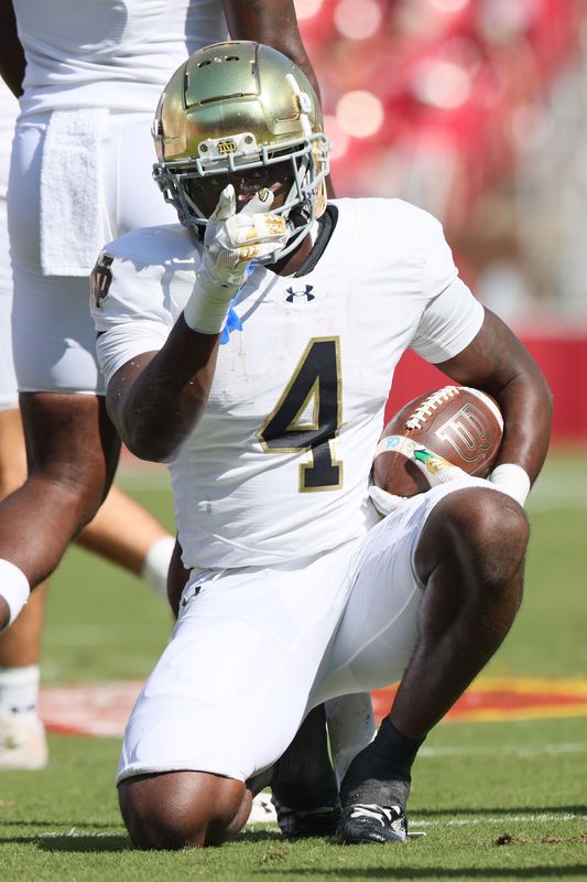 Sep 27, 2025; Fayetteville, Arkansas, USA; Notre Dame Fighting Irish running back Jeremiyah Love (4) signals first down after a run in the first quarter against the Arkansas Razorbacks at Donald W. Reynolds Razorback Stadium. Mandatory Credit: Nelson Chenault-Imagn Images