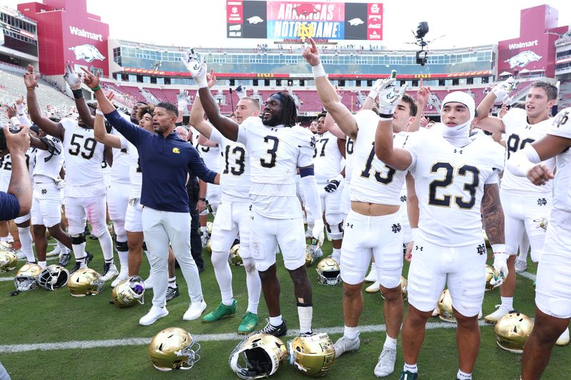 Sep 27, 2025; Fayetteville, Arkansas, USA; Notre Dame Fighting Irish head coach Marcus Freeman leads the team in celebration after the game against the Arkansas Razorbacks at Donald W. Reynolds Razorback Stadium. Notre Dame won 56-13. Mandatory Credit: Nelson Chenault-Imagn Images