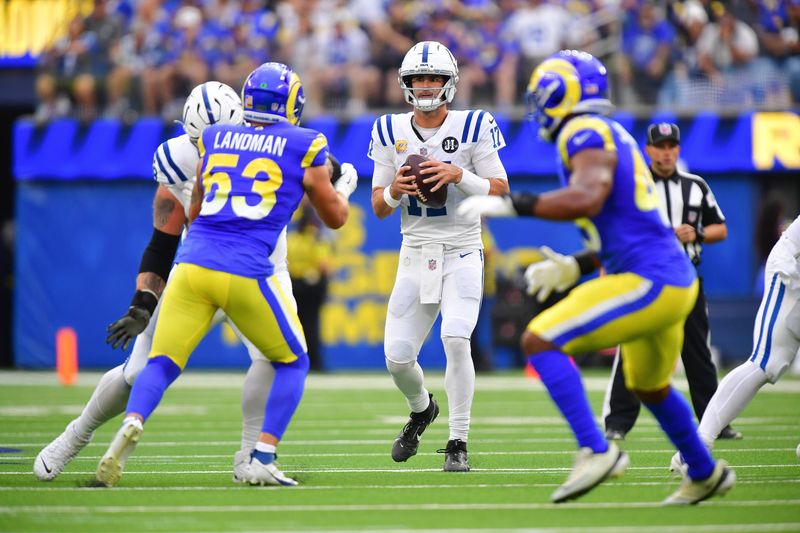 Sep 28, 2025; Inglewood, California, USA; Indianapolis Colts quarterback Daniel Jones (17) drops back to pass as Los Angeles Rams linebacker Nate Landman (53) moves in during the first half at SoFi Stadium. Mandatory Credit: Gary A. Vasquez-Imagn Images