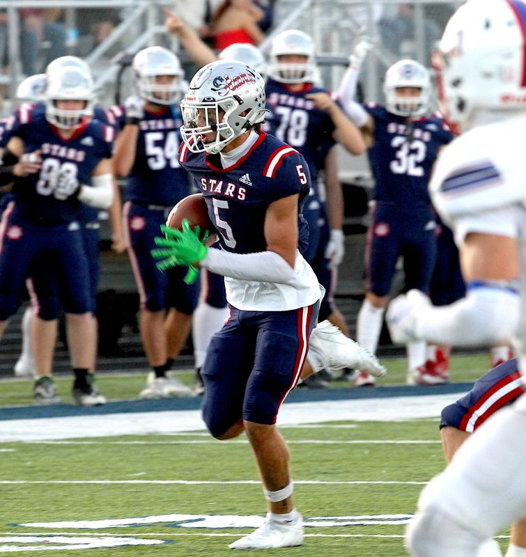 Bedford North Lawrence's Luke Morris (5) runs for the end zone after recovering a fumble.