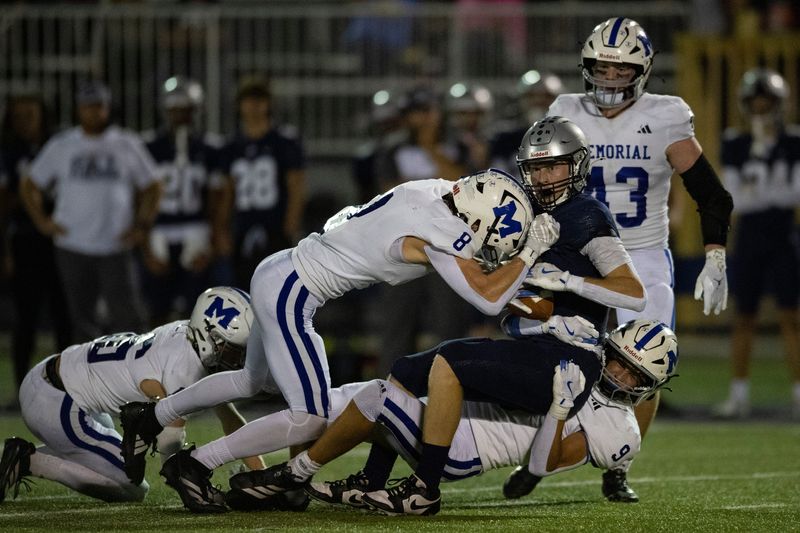 Reitz's Lucas Feldmann (1) is tackled as the Reitz Panthers play the Memorial Tigers at the Reitz Bowl in Evansville, Ind., Friday, Oct. 3, 2025.