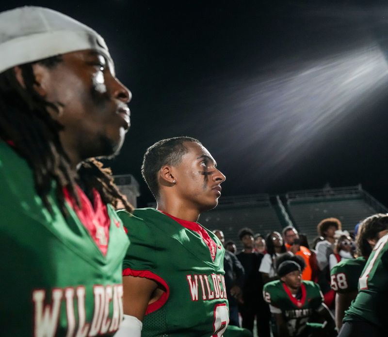 Lawrence North Wildcats defensive back Tyrin Woodson (4) and Lawrence North Wildcats Jaiden Byers (8) listen to Lawrence North Wildcats head coach Pat Mallory on Friday, Oct. 3, 2025, during a game between the Lawrence North Wildcats and Warren Central at Lawrence North High School in Indianapolis.