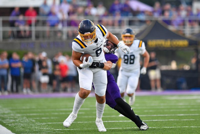 Moeller tight end Cooper McCutchan (8) tries to evade a defender during the high school football game between Archbishop Moeller and Elder at the ‘Pit’ on Friday, Oct. 3, 2025, in Cincinnati, Ohio. Elder defeated Moeller 24-16.