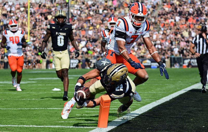 Purdue running back Antonio Harris dives with the ball short of the goal line against Illinois defensive back Matthew Bailey on Saturday, Oct. 4, 2025, at Ross-Ade Stadium in West Lafayette.