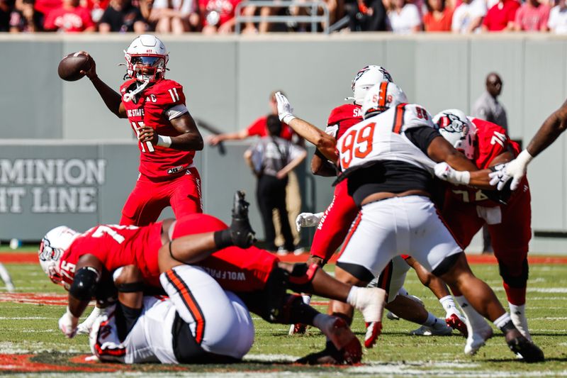 Oct 4, 2025; Raleigh, North Carolina, USA; NC State Wolfpack quarterback CJ Bailey (11) prepares to throw the ball during the first half of the game against Campbell Fighting Camels at Carter-Finley Stadium. Mandatory Credit: Jaylynn Nash-Imagn Images