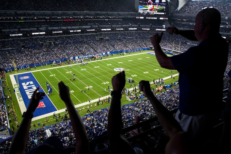 Fans dance as athletes run to the sideline for a timeout Sunday, Oct. 5, 2025, during a game against the Las Vegas Raiders at Lucas Oil Stadium in Indianapolis. The Indianapolis Colts defeated the Las Vegas Raiders, 40-6.