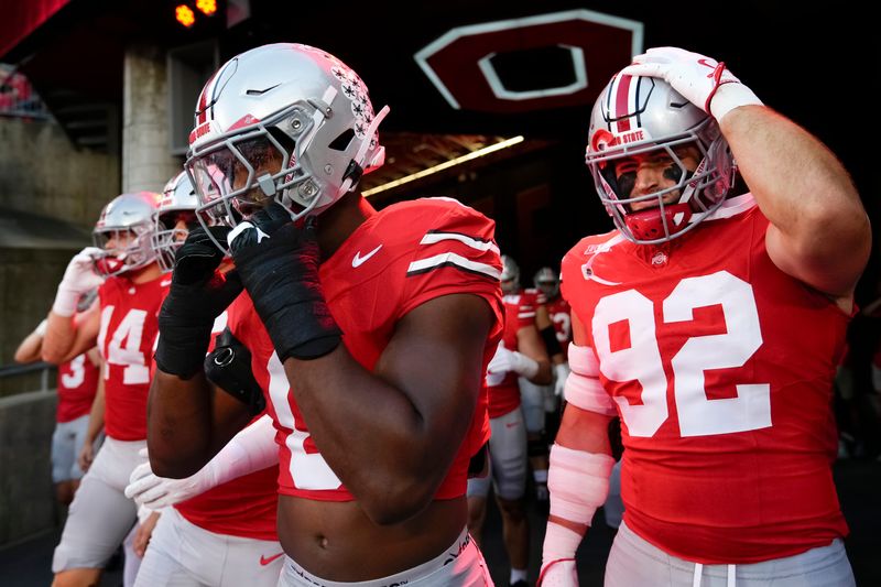 Ohio State Buckeyes linebacker Sonny Styles and defensive end Caden Curry (92) take the field for warm ups prior to the NCAA football game against the Minnesota Golden Gophers at Ohio Stadium in Columbus on Oct. 4, 2025.