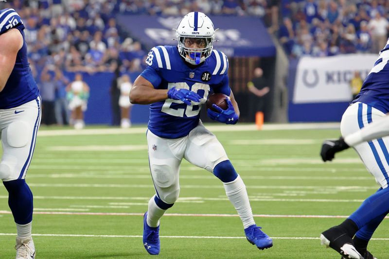 Oct 5, 2025; Indianapolis, Indiana, USA; Indianapolis Colts running back Jonathan Taylor (28) runs with the ball against the Las Vegas Raiders during the second quarter at Lucas Oil Stadium. Mandatory Credit: Trevor Ruszkowski-Imagn Images