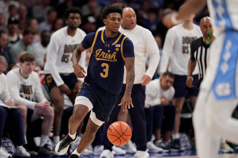 Mar 12, 2025; Charlotte, NC, USA; Notre Dame Fighting Irish guard Markus Burton (3) brings the ball up court against the North Carolina Tar Heels during the first half at Spectrum Center. Mandatory Credit: Jim Dedmon-Imagn Images