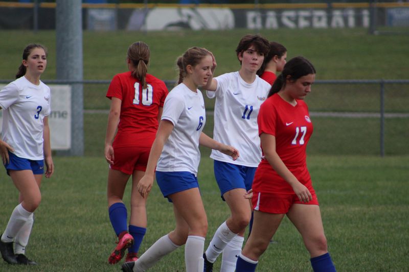 Muncie Burris senior forward Sydney Jackson (11) taps her teammate, junior forward Stella Beumer (6), on the head after Beumer scored a goal during the Owls' 9-0 win over Union County in the Sectional 42 first round at Centerville High School.