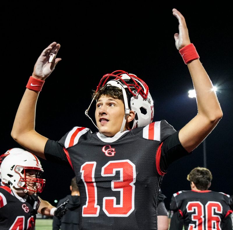 Center Grove quarterback Oscar Sloan (13) cheers toward the crowd Friday, Oct. 10, 2025, during a game between Center Grove and the Lawrence North Wildcats at Center Grove High School in Greenwood. Center Grove defeated the Lawrence North Wildcats, 38-35.