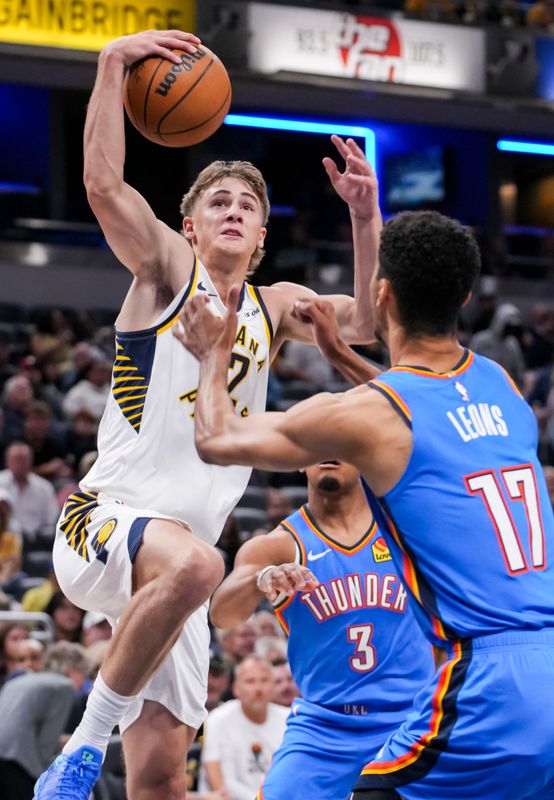 Indiana Pacers guard Johnny Furphy (12) goes up for a a basket against Oklahoma City Thunder forward Malevy Leons (17) on Saturday, Oct. 11, 2025, during a preseason game between the Indiana Pacers and the Oklahoma City Thunder at Gainbridge Fieldhouse in Indianapolis.