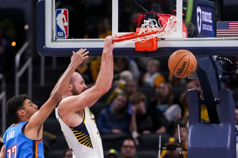 Indiana Pacers center Jay Huff (32) dunks Saturday, Oct. 11, 2025, during a preseason game between the Indiana Pacers and the Oklahoma City Thunder at Gainbridge Fieldhouse in Indianapolis. The Indiana Pacers defeated the Oklahoma City Thunder, 116-101.