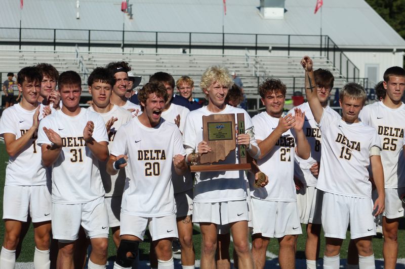 Delta junior midfielder Cooper Pierce holds the trophy after the Eagles won the IHSAA boys soccer Class 2A Sectional 23 championship at Mississinewa High School on Saturday, Oct. 11, 2025.