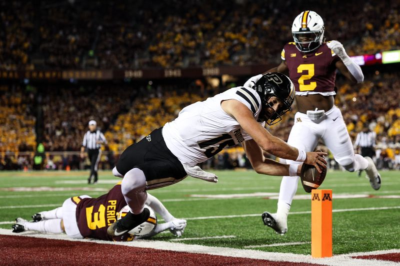 Oct 11, 2025; Minneapolis, Minnesota, USA; Purdue Boilermakers quarterback Ryan Browne (15) dives for a touchdown against the Minnesota Golden Gophers during the first half at Huntington Bank Stadium. Mandatory Credit: Matt Krohn-Imagn Images