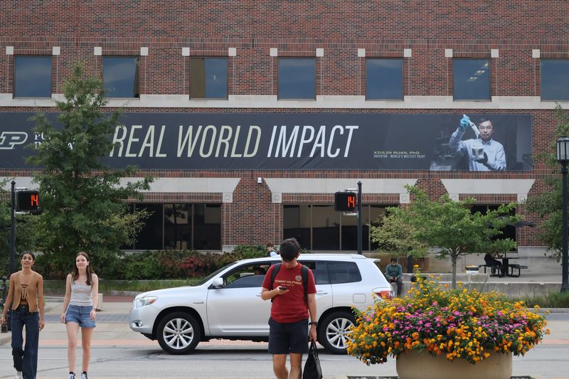Purdue touted in 2021 - including in this campus banner on Northwestern Avenue in West Lafayette - the invention of the "whitest paint in the world" that could counteract rising temperatures. But four years later, some are wondering where it's gone.