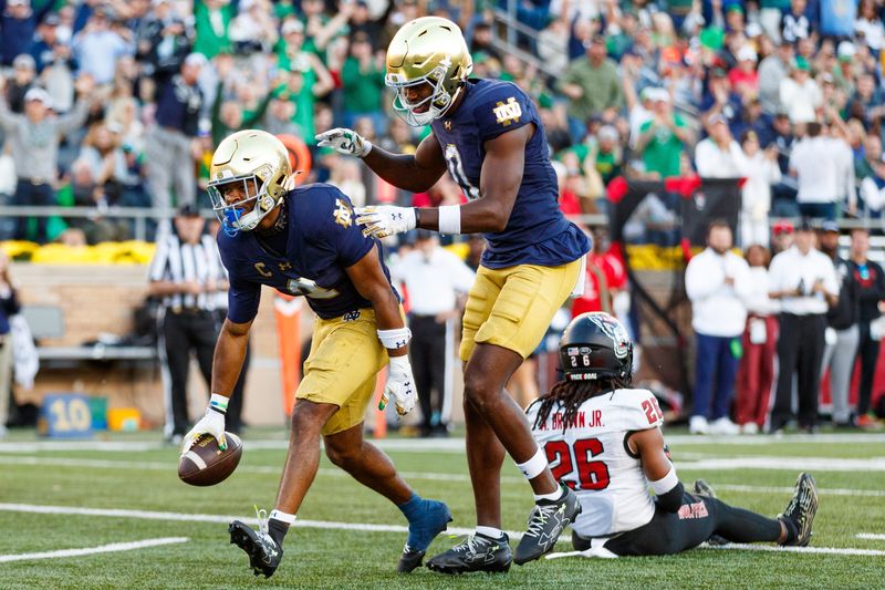 Notre Dame wide receiver Will Pauling, left, celebrates after scoring a touchdown in the second half of a NCAA football game against NC State at Notre Dame Stadium on Saturday, Oct. 11, 2025, in South Bend.