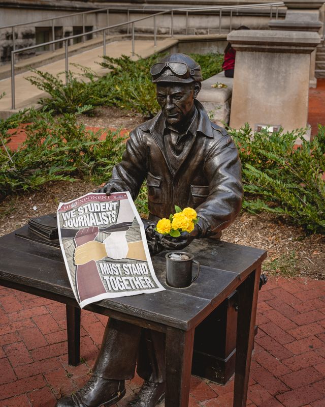 The statue of pulitzer Prize-winning war correspondent and Indiana Daily Student alum Ernie Pyle holds a copy of The Purdue Exponent's IDS Special Edition.