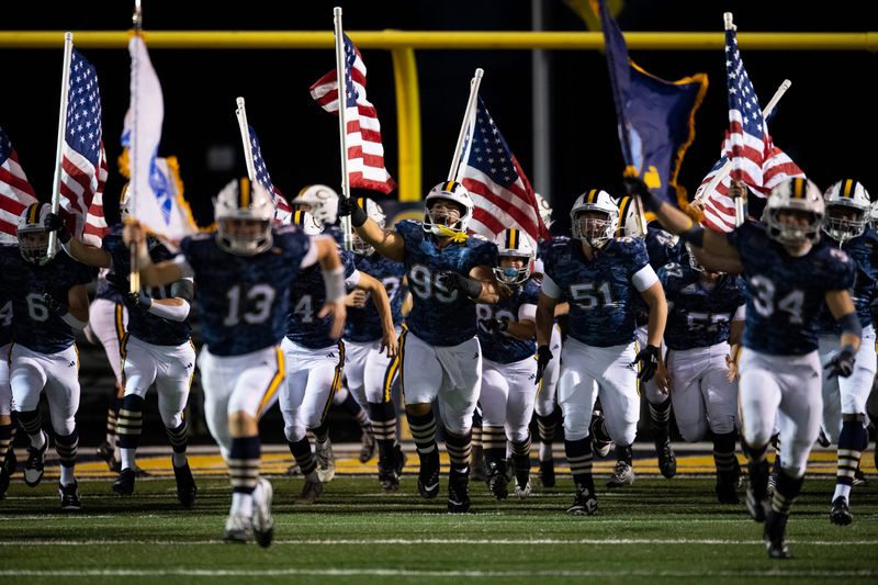 The Castle Knights take the field ahead of their games against the Memorial Tigers at Castle High School in Newburgh, Ind., Friday, Oct. 17, 2025.