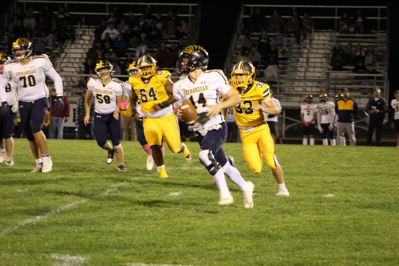 Shenandoah quarterback Jarrett Helman rolls out of the pocket during the Raiders' game at Monroe Central on Friday, Oct. 17, 2025.