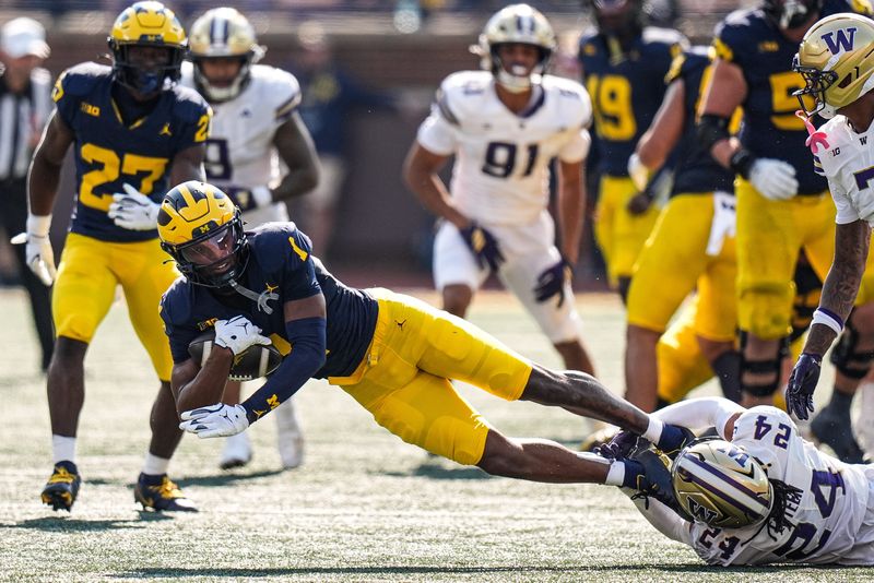 Michigan wide receiver Donaven McCulley (1) makes a catch against Washington safety Makell Esteen (24) during the first half at Michigan Stadium in Ann Arbor on Saturday, Oct. 18, 2025.