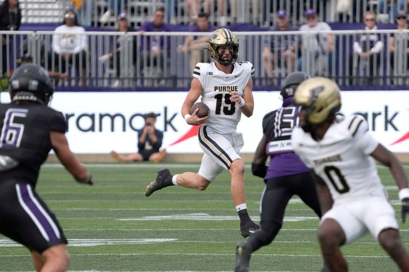 Oct 18, 2025; Evanston, Illinois, USA; Purdue Boilermakers quarterback Ryan Browne (15) runs the ball against the Northwestern Wildcats during the first half at Northwestern Medicine Field at Martin Stadium. Mandatory Credit: David Banks-Imagn Images