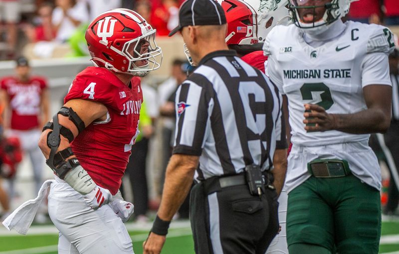 Indiana's Aiden Fisher (4) celebrates his tackle for a loss on Michigan State's Makhi Frazier (5) during the Indiana versus Michigan State football game at Memorial Stadium on Saturday, Oct. 18, 2025.
